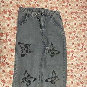 High rise wide leg denim jeans with black butterfly decals